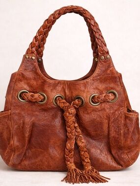 Kooba “Carla” light brown leather shoulder bag w/braiding detail & side pockets